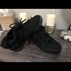 Black sneakers with fur around the ankles